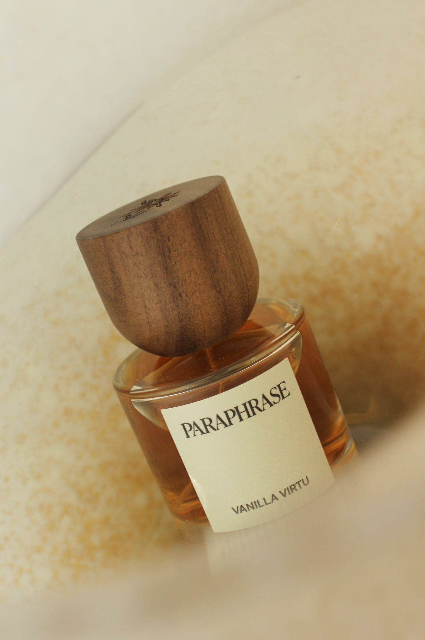 Perfume bottle with vanilla textured background.