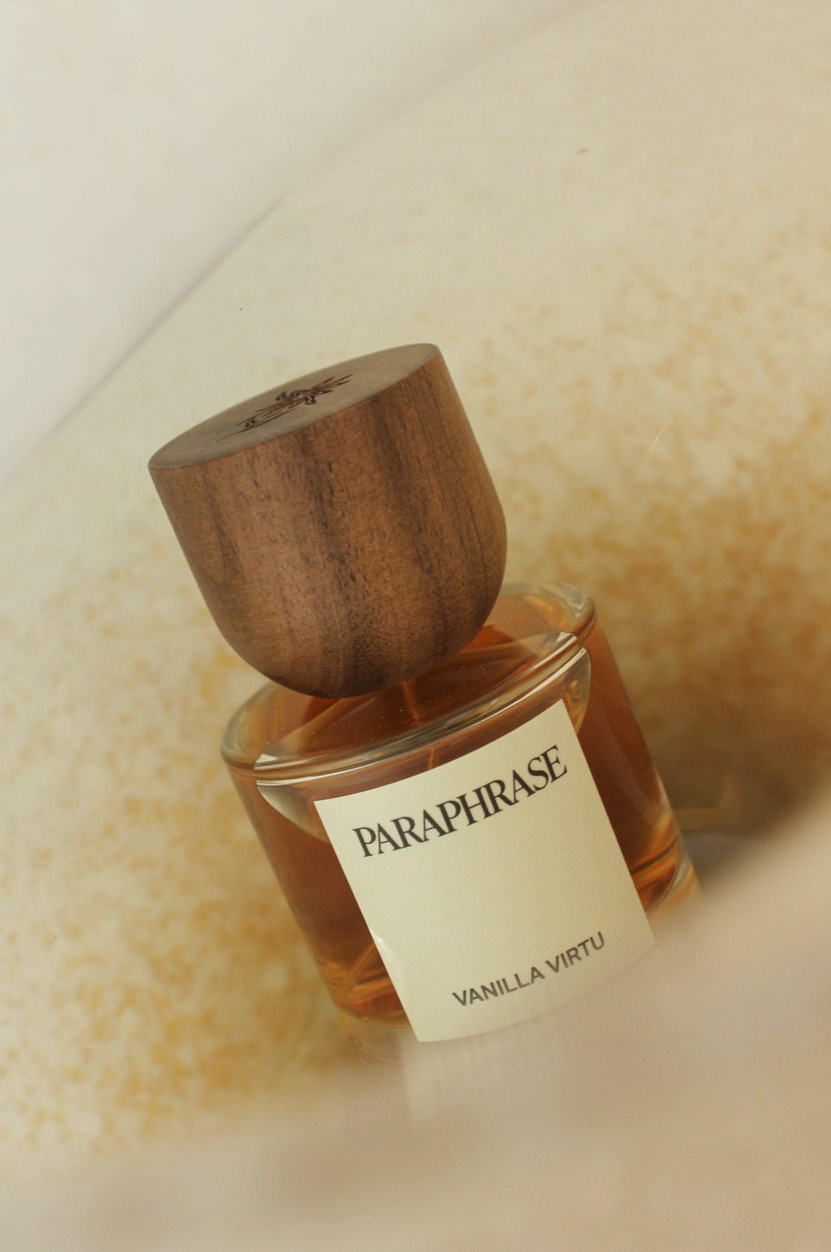 Perfume bottle with vanilla textured background.
