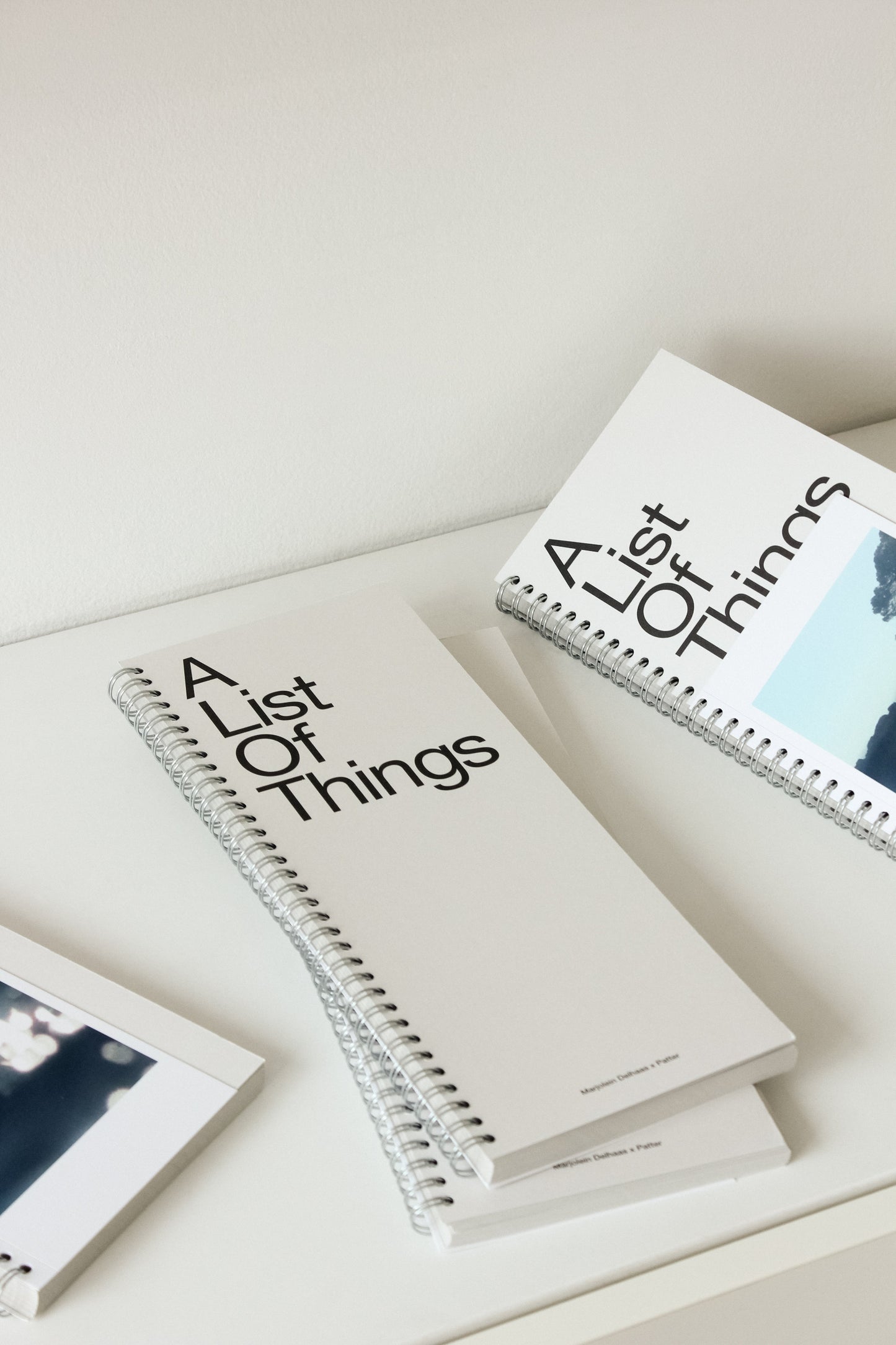 Two cream notebooks titled 'A List Of Things' on a desk.