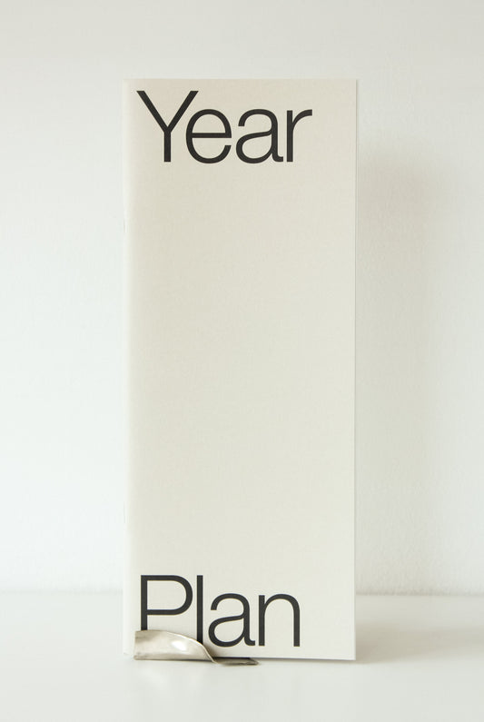 Narrow Year Plan yearly agenda in soft cream with black sans serif text.