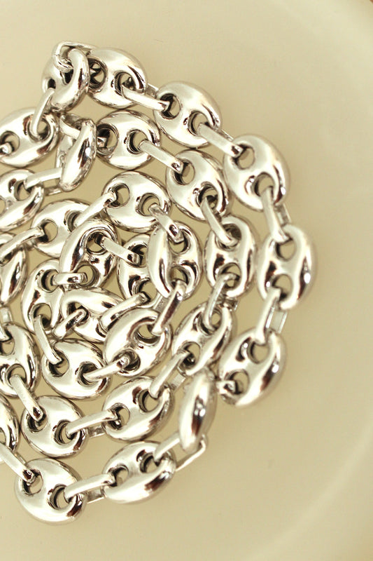 Detail of puffy mariner link sterling silver chain necklace.